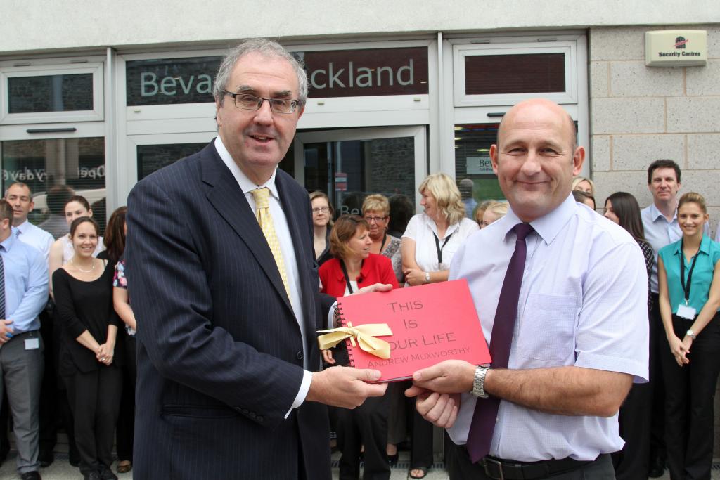 Andrew Muxworthy Accountant at Bevan Buckland, receiving This is Your Life book